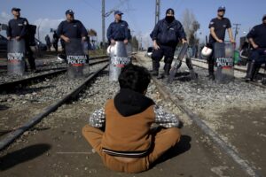 A refugee stands in front of a Greek riot police cordon during a protest at the Greek-Macedonian border, near the Greek village of Idomeni, March 1, 2016. REUTERS/Alexandros Avramidis      TPX IMAGES OF THE DAY